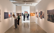 A shot inside the Earth Photo exhibition with guests viewing the photographs.