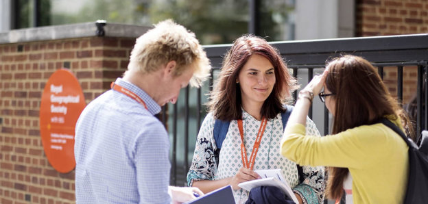 Three people chatting outside RGS Buildling