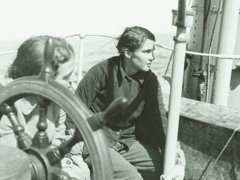 Two members of the British East Greenland Expedition 1935-1936 aboard a boat.
