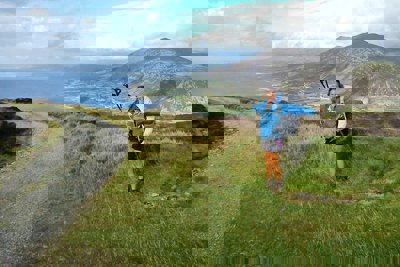 Zoe Langley-Wathen on a coastal path in Wales. She is smiling